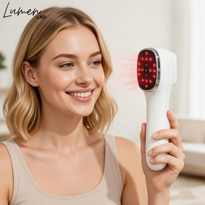 Woman holding a white led therapy electronic device with red lights, smiling in a bright room.